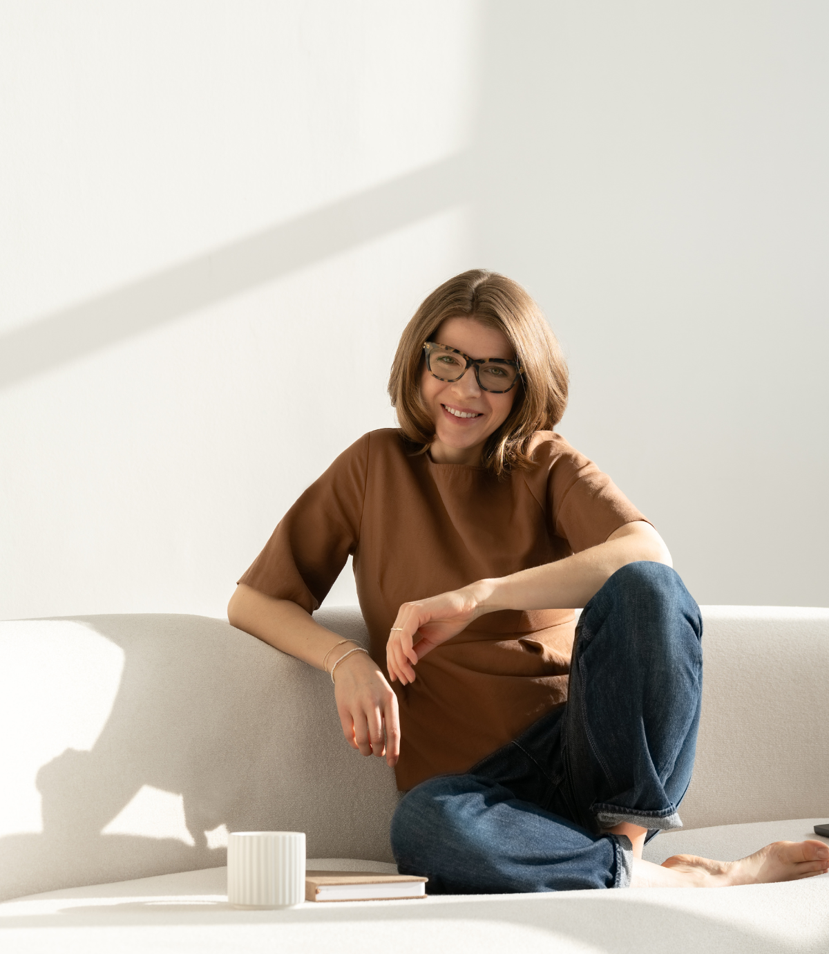 lacourage-strategisches-branding-small Laura, Brand Designerin bei LaCourage, entspannt sitzend auf dem Sofa, erklärt warum Kunden bei LaCourage buchen sollten